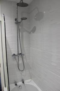 a shower with a shower head in a bathroom at Oliver Wests Beautiful 1 Bedroom Retreat in Scarborough +31 photos