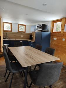 a kitchen with a wooden table and chairs at Chalet-Hôtel de l'Etape in Les Contamines-Montjoie