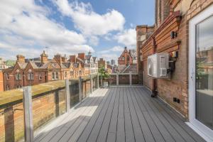 an outdoor deck with a view of a city at The Pocklington Aparthotel - Luxury 1 & 2 Bed Serviced Apartments, City Centre, Perfect For Families, Contractors and Businesses in Leicester