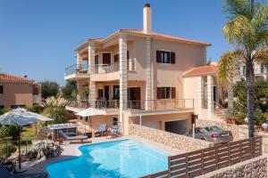a villa with a swimming pool and a house at Villa Omega Kefalonia in Karavádhos