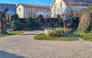 a house with a driveway in front of a yard at Location Cosy De Plain-Pied in Audincourt
