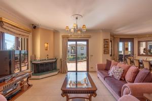 a living room with a couch and a fireplace at Villa Omega Kefalonia in Karavádhos