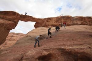 a group of people walking on a rock formation at Wadi rum fun time in Wadi Rum +3 photos