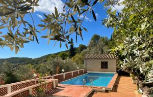 a swimming pool in a garden with a house at La Nature in Seillans