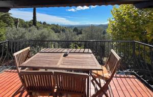 a wooden table with two chairs on a balcony at La Nature in Seillans +7 photos