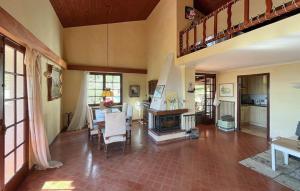 a living room with a fireplace and a staircase at La Nature in Seillans