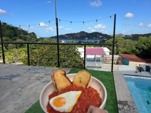 a plate of food with eggs and bread on a table at Buena Onda Backpackers in San Juan del Sur