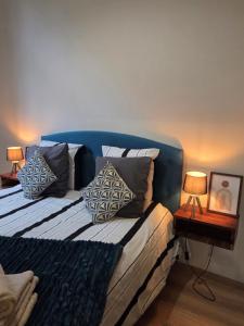 a bed with pillows on it in a room at La Pause Dinannaise in Dinan