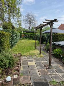 a garden with a wooden pergola in a yard at Zum Josefstal zwei in Sankt Ingbert