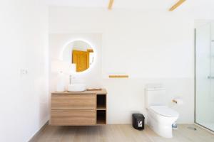 a bathroom with a sink and a toilet and a mirror at Eden Rentals Costa Boho 2 in Las Galletas