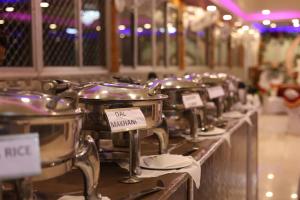 a row of pots and pans on a buffet line at ANAND LOK VATIKA in Rājgīr