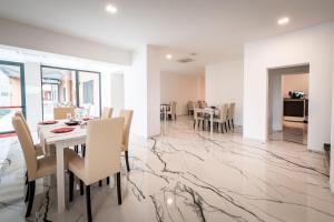 a dining room with marble flooring and a table and chairs at Hotel Cajeta in Buia