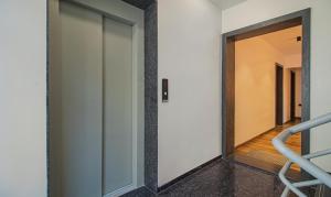 a hallway with a glass door and a staircase at Treebo Atithi Comforts Inn in Pune
