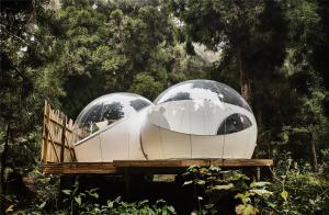 two domes on a wooden platform in a forest at KAZ INSOLITE in Saint-Louis