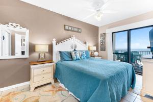 a bedroom with a bed and a view of the ocean at Phoenix 6 Unit 1209 in Orange Beach