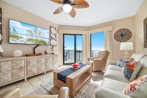a living room with a couch and a tv at Phoenix 6 Unit 1209 in Orange Beach