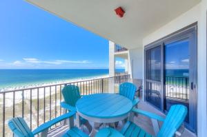 a table and chairs on a balcony with the beach at Phoenix 6 Unit 1209 in Orange Beach