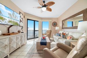 a living room with a couch and a tv at Phoenix 6 Unit 1209 in Orange Beach