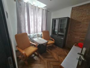 a room with two chairs and a table and a television at Noclegi w Sercu Miasta in Sanok +18 photos