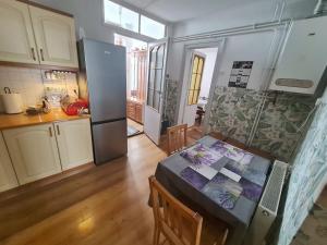a kitchen with a table and a refrigerator in a room at Noclegi w Sercu Miasta in Sanok