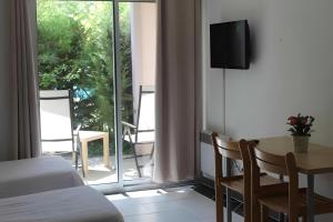 a bedroom with a bed and a table and a window at Les Canyons du Verdon in Castellane +44 photos