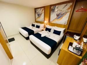 a hotel room with two beds and a shower at City Central Hotel in Kuala Lumpur