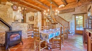 a dining room with a table and a wood stove at Chez Moutier in Monestier