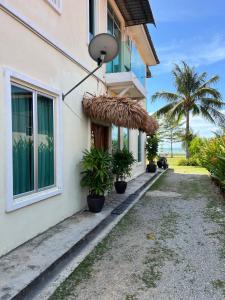 a building with potted plants on the side of it at JAR NON Villa in Pantai Kok