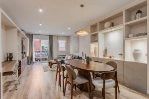 a kitchen and living room with a table and chairs at Comfortable and spacious flat in Barcelona in Barcelona