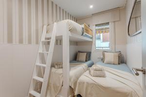 a bedroom with two bunk beds and a ladder at Comfortable and spacious flat in Barcelona in Barcelona