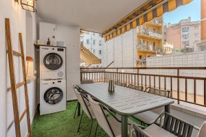 a balcony with a table and a washing machine at Comfortable and spacious flat in Barcelona in Barcelona