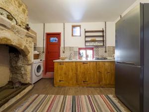a kitchen with a refrigerator and a stove at Fatma Hanoum Old Town in Rhodes Town +31 photos