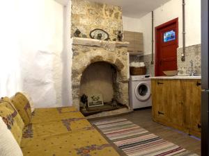 a kitchen with a stone fireplace in a room at Fatma Hanoum Old Town in Rhodes Town