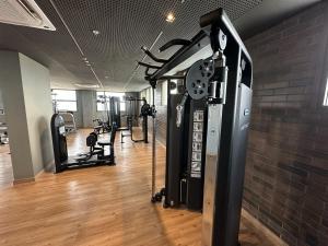 a room with a gym with a clock on the wall at Palazzo Torquetti in Belo Horizonte