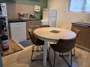a kitchen with a table and chairs in a room at Git chez BOUBET 1 in Arnos