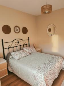 a bedroom with a bed with a white comforter at Casa las granxias in El Escobal