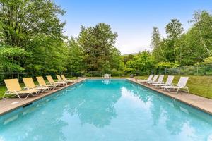 a swimming pool with lounge chairs at Southface #35 in Warren