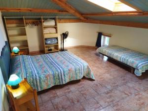 a bedroom with two beds in a room at Gîte Le Provençal in Vagnas +16 photos