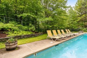 a group of chairs sitting next to a swimming pool at Southface #35 in Warren