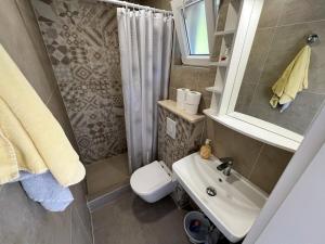 a bathroom with a sink and a toilet and a shower at Robinson Olympos in Gdinj +51 photos