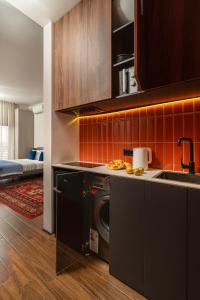 a kitchen with a washer and a sink and a stove at Blueloft 47 l studio with balcony Tashkent City Center in Tashkent