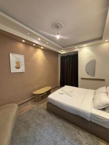 a hotel room with a bed and a table at Alex inn Rooms in Alexandria