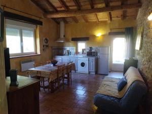 a kitchen and dining room with a table and a couch at Gîte Le Provençal in Vagnas