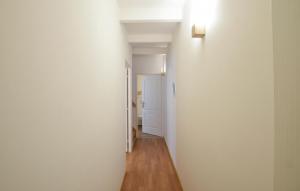 a hallway with a white wall and a white door at Maison Proche Port Et Plage in Saint-Vaast-la-Hougue +17 photos
