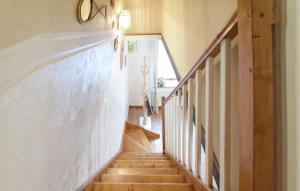 a staircase in a house with wooden floors at Maison Proche Port Et Plage in Saint-Vaast-la-Hougue