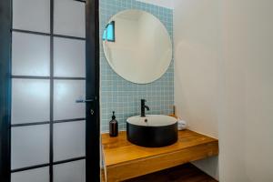 a bathroom with a sink and a mirror at Little Soho Pererenan in Canggu +26 photos