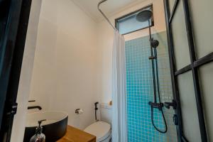 a bathroom with a shower with a sink and a toilet at Little Soho Pererenan in Canggu