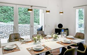 a dining room with a table and chairs and windows at Villa Rondo in Costa de la Calma