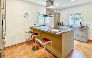 a kitchen with a large counter with stools in it at Villa Rondo in Costa de la Calma