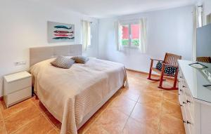 a bedroom with a bed and a table and windows at Villa Rondo in Costa de la Calma +10 photos